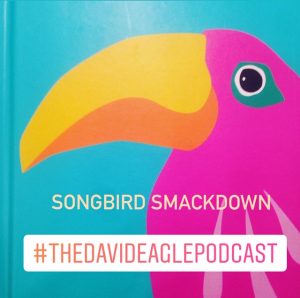 A pink cartoon parrot on a blue background with the text "Songbird Smackdown" and the hashtag of The David Eagle Podcast