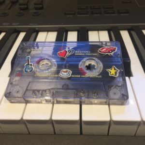 A cassette tape on a keyboard
